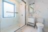 Full bath with a marble finish shower, vanity, and light marble finish flooring