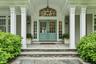 Double door entry with blue stone walkways and covered area with seating