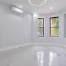 Spare room with finished concrete floors, a wall mounted air conditioner, and recessed lighting