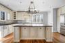 Kitchen with center island and room for 2-4 stools.