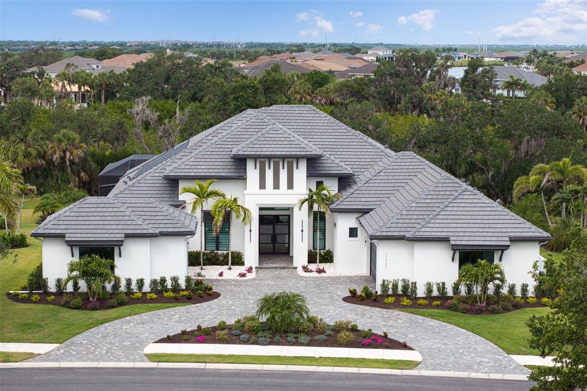 Tucked behind the gates of Parrish’s most exclusive waterfront community, this extraordinary custom residence is built by renowned luxury builder Arth