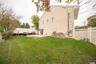 Back of house with big yard- vinyl fencing and patio area