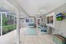 Relaxing patio area under roof with ceiling fans, perfect for parties and barbeques.