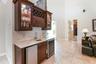 Bar with ice maker, wine/beverage  refrigerator and sink.