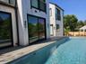View of swimming pool with a deck and a fenced in pool