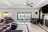 Living room with inlaid floor details, coffered ceiling, french doors, beamed ceiling, and ornamental molding
