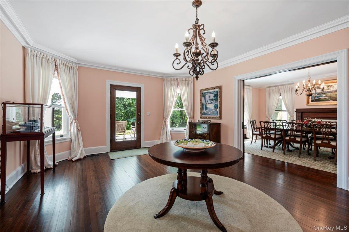 Restored rich wood floors, oversized windows, base and ceiling moldings and paneled pocket doors