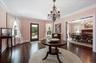 Restored rich wood floors, oversized windows, base and ceiling moldings and paneled pocket doors