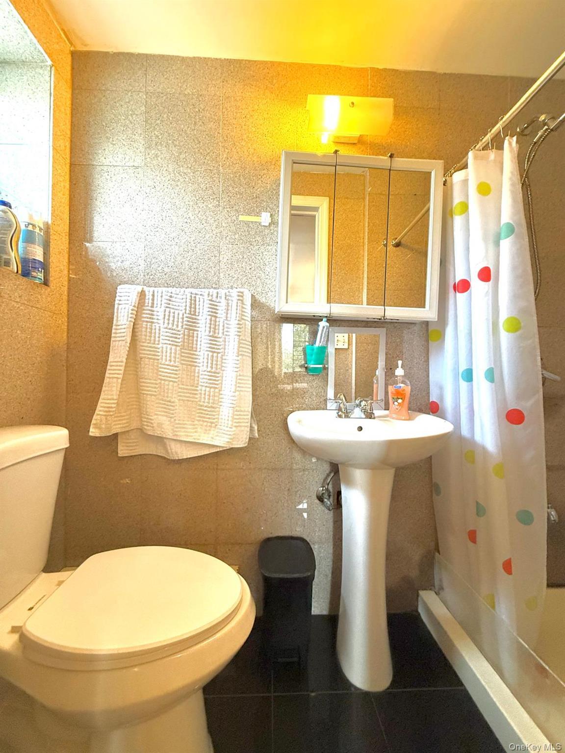 Master Full bathroom with a stall shower, tile walls, and tile patterned floors