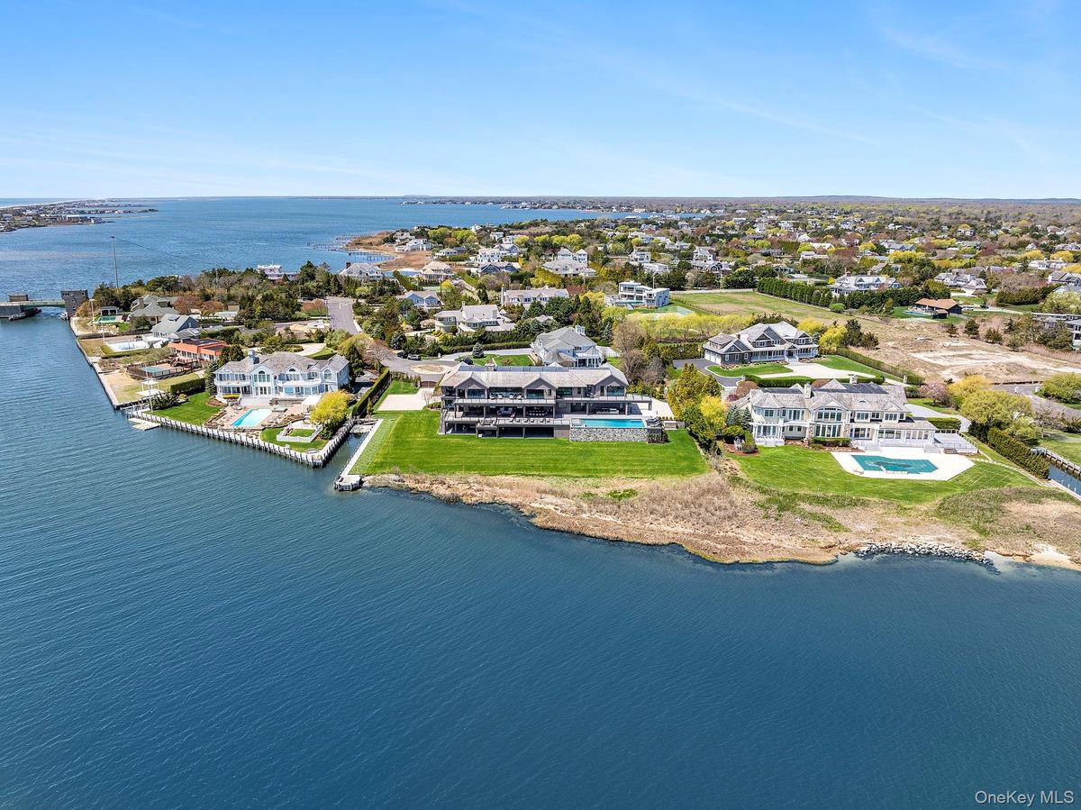 Aerial view of residential area featuring a large body of water