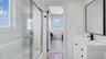 Shared Bathroom with combined bath / shower with glass door, vanity, and ensuite bathroom