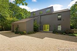 Rear view of house featuring driveway