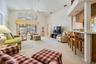 Spacious Family Room with Vaulted Ceilings, lots of sunlight and a ceiling fan.
