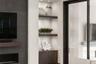 The custom built-in cabinetry and shelving has accent lighting.