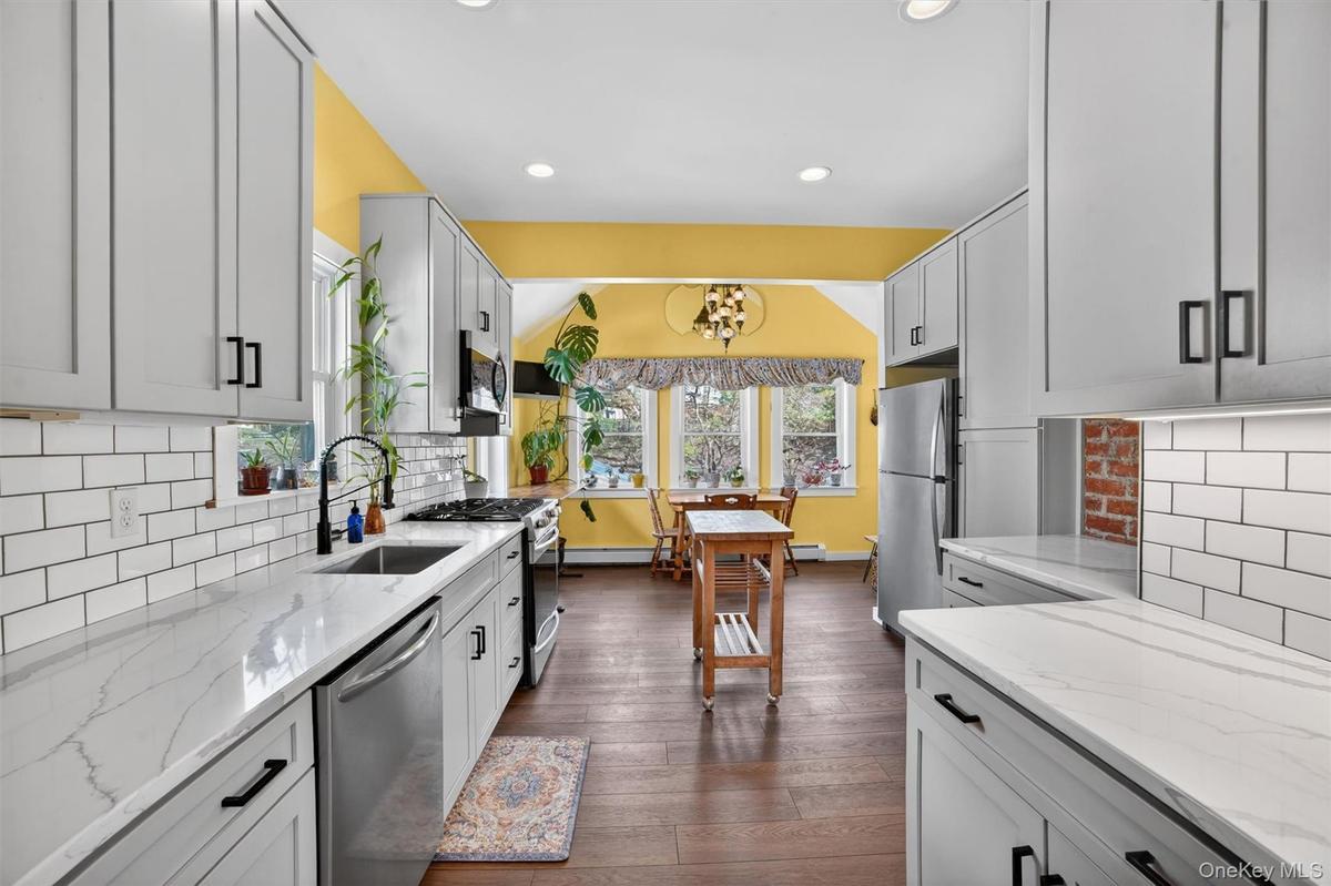 Updated kitchen featuring beautiful quartz countertops.