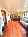 Living area with dark wood-style floors and baseboards