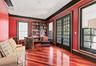 Richly stained wood-finish flooring complements the vibrant walls
