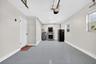 Single garage with garage door opened. Fresh epoxy flooring. Garage stacked washer and dryer.