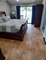 Primary bedroom with access to pool and backyard