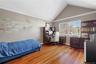 Upper Bedrm, vaulted ceiling with white crown molding, wood-finish flooring, and a large window