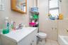 Full bathroom with tile walls, vanity, light tile patterned floors, and bathing tub / shower combination