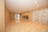 Den with tile floors. Sliders leading to patio area outside.