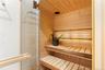 Relaxing sauna featuring wood ceiling