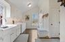 Washroom featuring baseboards, dark wood-style floors, washer and clothes dryer, cabinet space, and a sink
