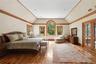 Bedroom featuring lofted ceiling, crown molding, light wood-style flooring, and french doors