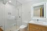 Full bath featuring a stall shower and vanity