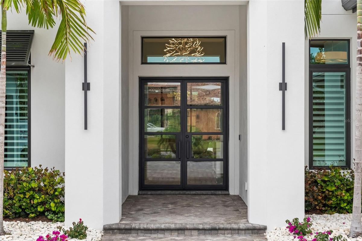 It is perfectly positioned on over a half-acre homesite with tropical preserve views and accompanied by a deeded private boat dock!