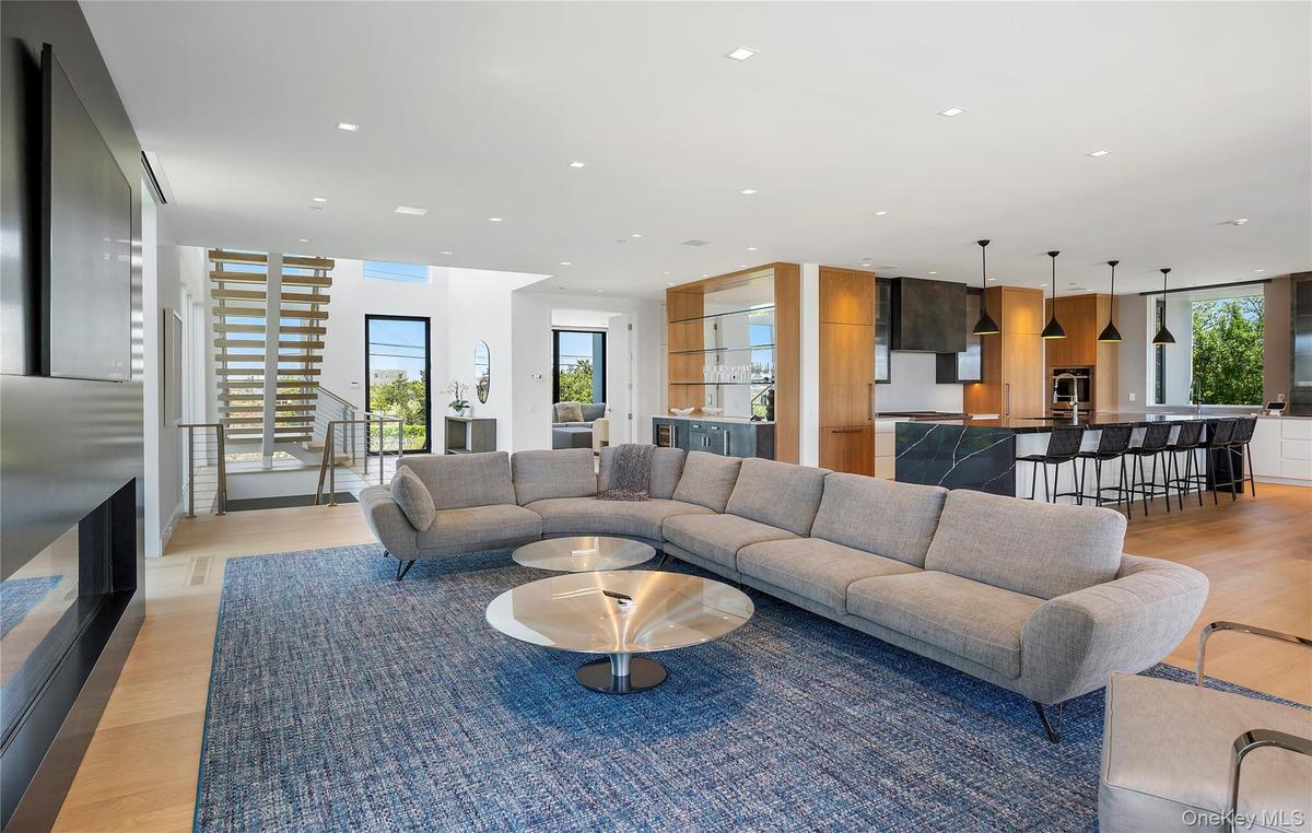 Living area featuring light wood finished floors and recessed lighting