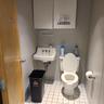Half bathroom with tile patterned floors, a sink, toilet, and baseboards