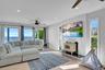 Living area featuring a ceiling fan, a wood stove, wood finished floors, and recessed lighting