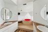 Bathroom with hardwood / wood-style floors, vanity, plenty of natural light, and a washtub
