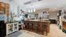 Kitchen with a peninsula, a breakfast bar area, appliances with stainless steel finishes, pendant lighting, and light wood finished floors