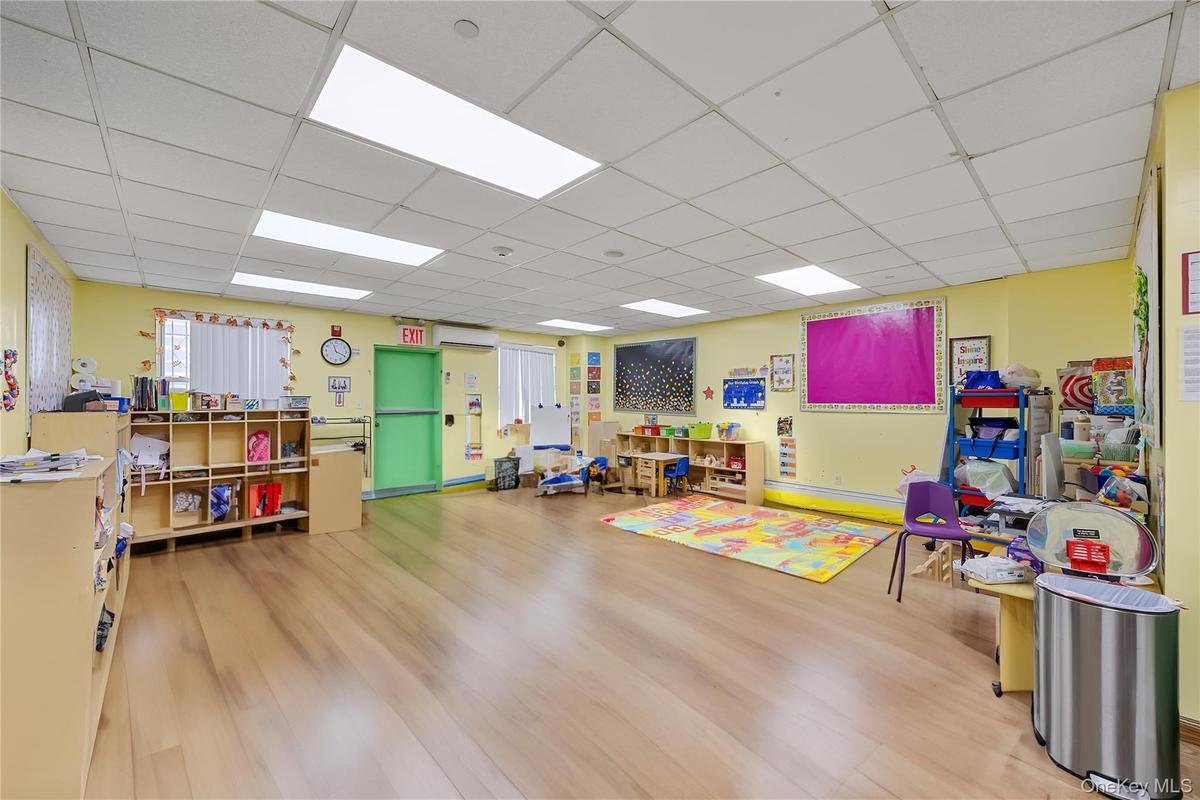 Rec room featuring wood finished floors and a paneled ceiling