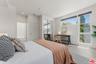 Bedroom offering wood-style fl