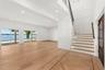 ELEGANT STAIRCASE ASCENDING TO A LOFT SANCTUARY WITH BREATHTAKING BALCONY VIEWS OF LAKE CONWAY