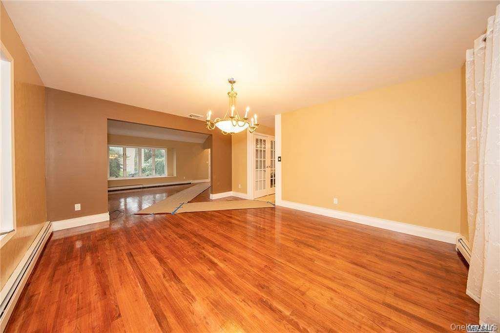 Glossy hardwood floors, open to dining room and Kitchen