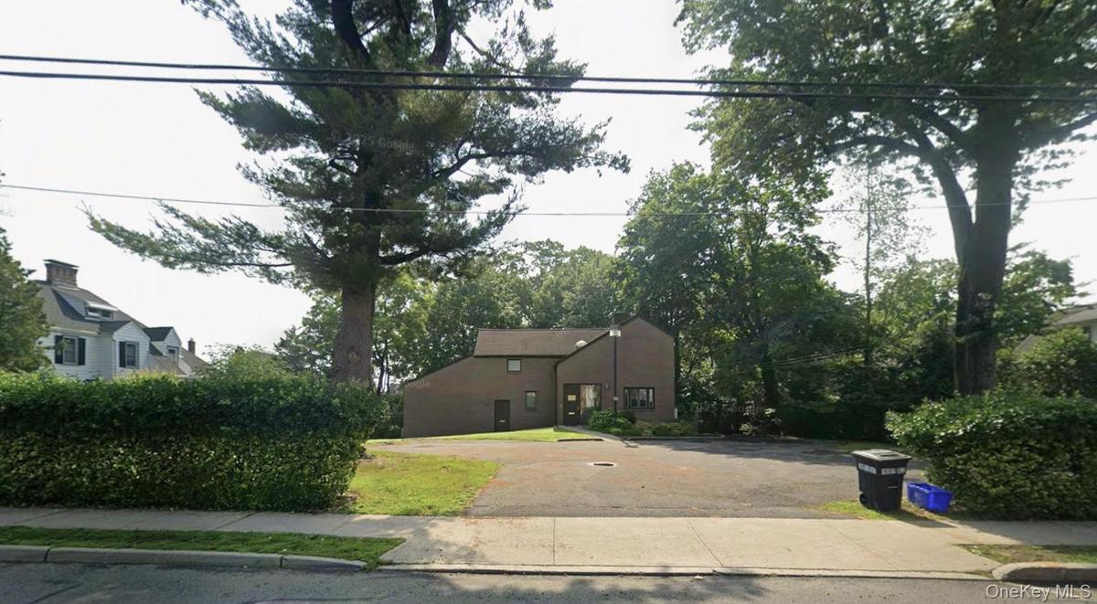 Prominent street view, yet tucked back behind mature landscaping.