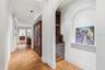Hall looking into built in Wine alcove with storage & wine fridge