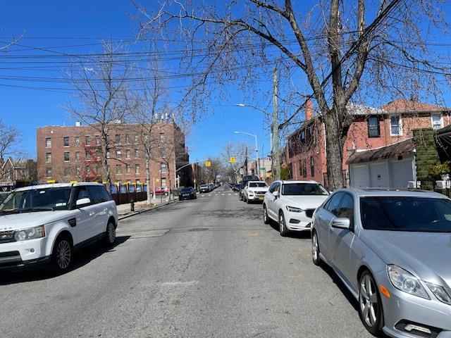 View of street with street lights, traffic lights, and a residential view