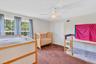 Neutral wall paint, ceiling fan with integrated lighting, brown carpet flooring, and white trim