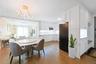 Dining area with light wood-type flooring, crown molding, and a chandelier