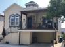 View of front facade with stucco siding, stairway, and a balcony