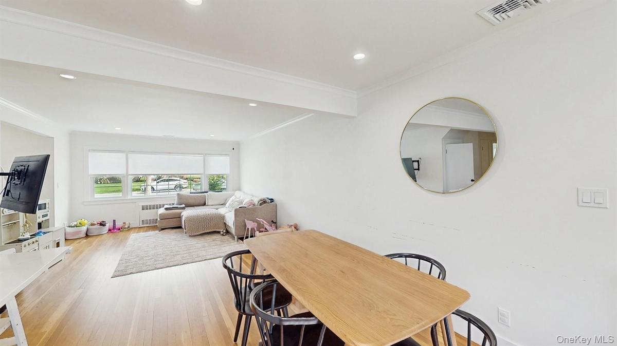 Dining space featuring visible vents, crown molding, light wood finished floors, radiator, and recessed lighting