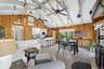 Vaulted white wood beam ceiling throughout an open concept living area featuring wood-finish flooring