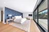 Bedroom featuring wallpapered walls, light wood-type flooring, an accent wall, recessed lighting, and access to outside