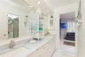 Remodeled Jack and Jill bath, double sinks, quartz counter top and marble flooring